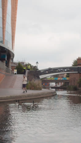 Vertical-Video-Of-View-From-Canal-Boat-Of-Shops-And-Office-Buildings-In-Birmingham-UK